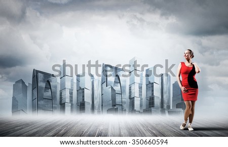 Gorgeous young ballet dancer wearing red dress over modern city background