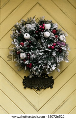stylish amazing christmas wreath on geometry door, celebration decoration for holidays in the city