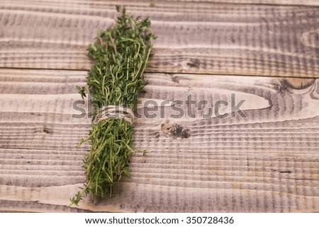 Branches of natural fresh organic juicy rosemary herb for cooking tied by twine seasoning ingredient with spicy savour studio on wooden background copyspace closeup, horizontal picture
