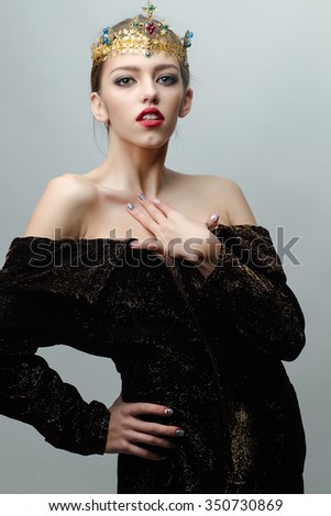 Portrait of beautiful majestic royal person of queen historic character with luxury precious shiny bright gold crown with colorful diamonds and gems standing with bare shoulders, horizontal picture