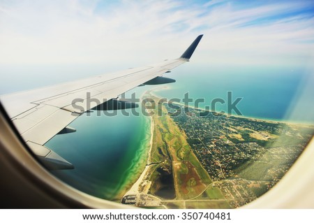 Looking through window aircraft, landing to Copenhagen airport Kastrup. High-angle view from airplane.  Royalty-Free Stock Photo #350740481