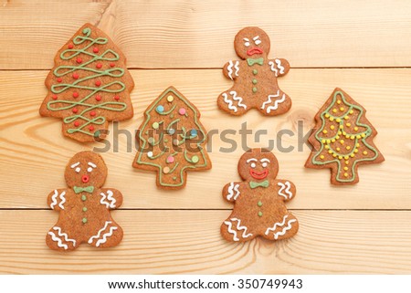 Traditional Christmas gingerbread cookies on wooden background
