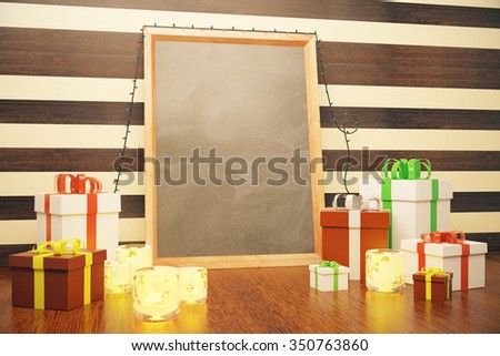 Blank picture frame with christmas gift boxes and lit candles