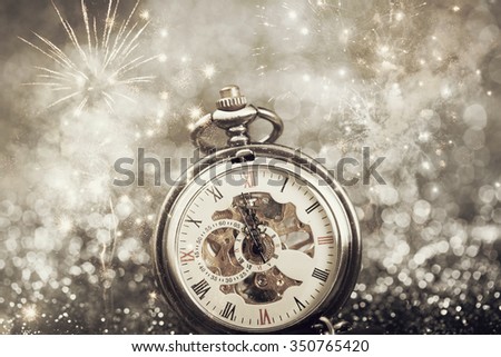 New Year's at midnight - Old clock with stars snowflakes and holiday lights