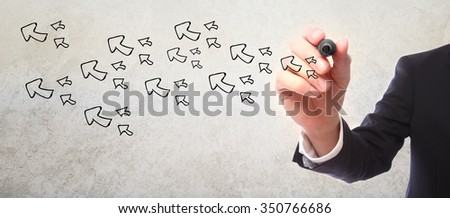 Businessman drawing Arrows with a black marker