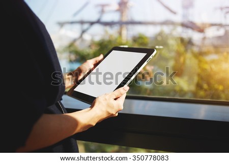 Cropped image of woman's hands holding touch pad with blank copy space screen for your text message or advertising content, businesswoman reading electronic book on digital tablet during work break