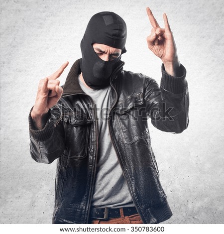 Robber making horn gesture
