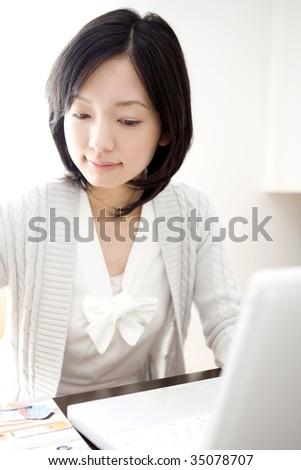 BUSINESS IMAGE-a beautiful Japanese woman using a PC laptop at work