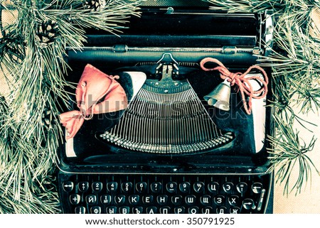 Vintage typewriter with Christmas tree fur. Photography for blog and creative banners, or hero image. Symbol of blogging, writing, internet activity and creativity.