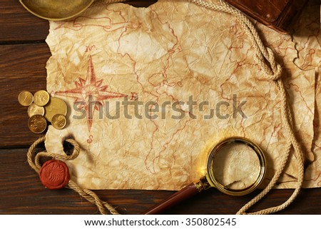 Vintage map and accessories for the treasure hunt and travel Royalty-Free Stock Photo #350802545