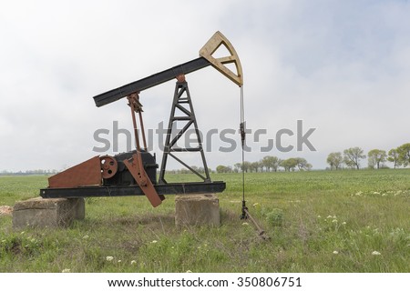 oil pump. Oil industry equipment. Work of oil pump jack on a oil field.
