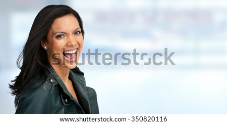 Beautiful laughing asian woman over blue banner background.