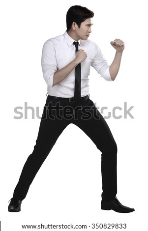 Man in white shirt doing fighting stance on white background Royalty-Free Stock Photo #350829833