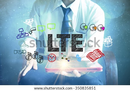 businessman holding a tablet computer with LTE text ,business concept 