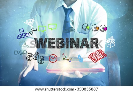 businessman holding a tablet computer with WEBINAR text ,business concept