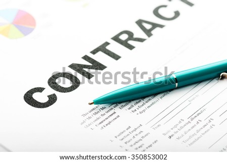 Businesswoman's hand with pen signing a contract. 