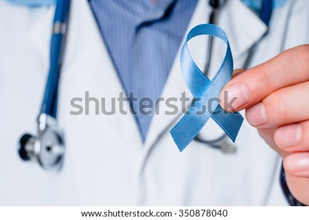Prostate cancer awareness. Blue ribbon in doctor hand. Man, male support, care, charity. Concept of medicine oncology closeup sky symbol. Carcinoma, achalasia help. Middle age person. Royalty-Free Stock Photo #350878040