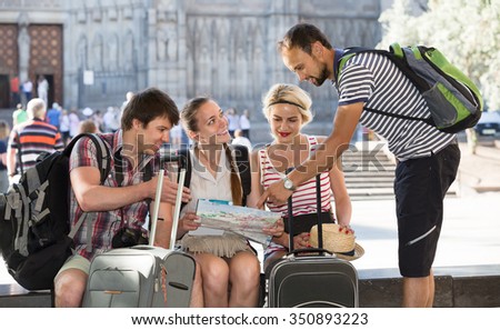 positive european tourists with map exploring the city destination