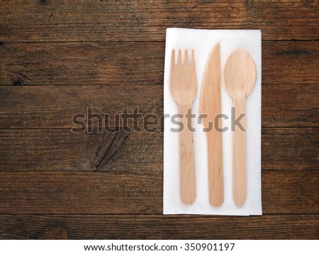 Ecological food background. Disposable wooden cutlery with white paper napkin. Royalty-Free Stock Photo #350901197