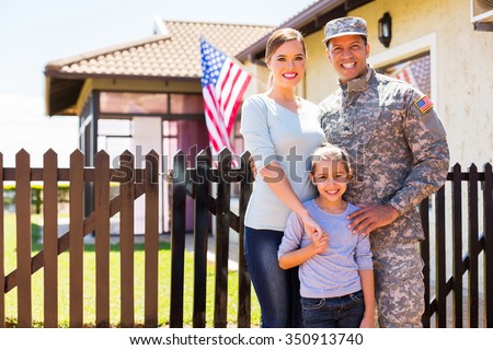 happy american soldier reunited with family outside their home Royalty-Free Stock Photo #350913740