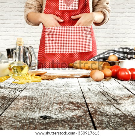 blurred background of kitchen place with table and oil and eggs and desk of flour 