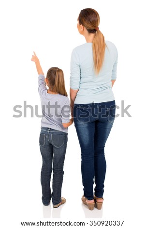 rear view of young mother and daughter pointing at empty space Royalty-Free Stock Photo #350920337