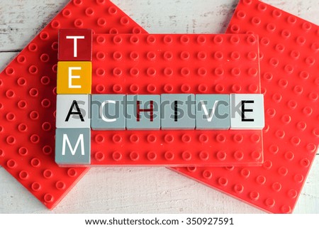 team achive word block on red template bussiness concept