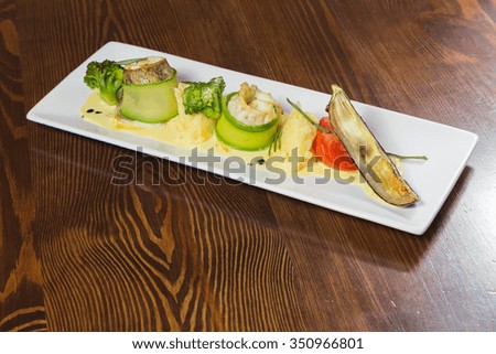 Fish with vegetables. Beautiful layout on a plate