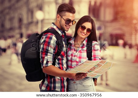 Happy tourists with map, outdoors