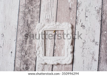 White photo frame on wooden wall, vintage background