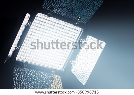 Professional LED lighting equipment for photo and video production in dark studio interior