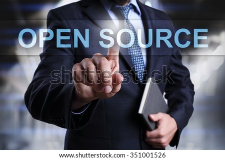 Businessman pressing button on touch screen interface and select open source. 