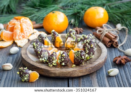 Mandarins covered with chocolate and pistachio Royalty-Free Stock Photo #351024167
