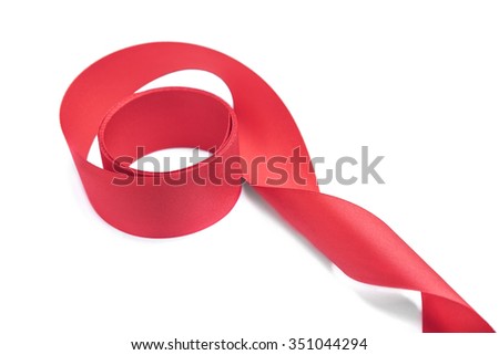 Skein of red satin ribbon on white background.