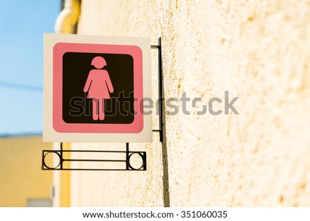 Public restroom signs with a lady symbol