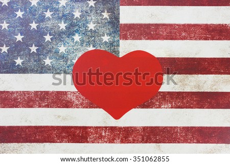 Blank red heart with rustic American canvas flag blurred in background
