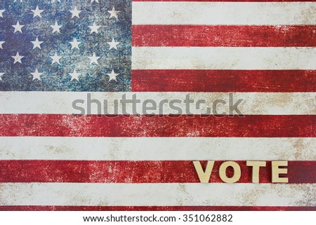The word VOTE on antique rustic American canvas flag in background