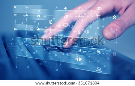 Hand pressing keyboard with high tech media icons and symbols