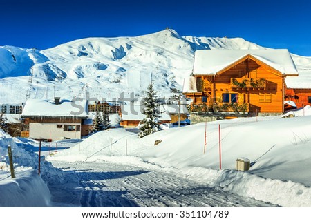 Stunning winter panorama with snowy road and village,La Toussuire,France,Europe Royalty-Free Stock Photo #351104789