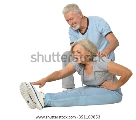 Portrait of Senior Couple Exercising On White Background