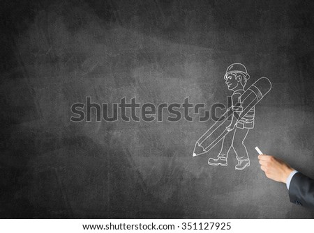 Male hand drawing with chalk engineer man on blackboard
