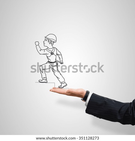 Drawn construction man in male palm on gray background