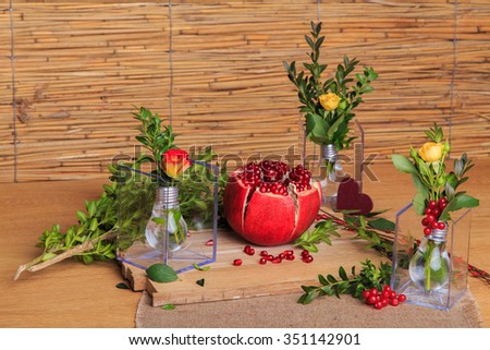 Still-life with a pomegranate on the wooden background