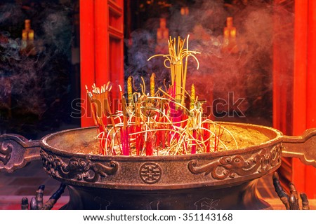 Burning Smoking Incense Sticks in Chinese Temple