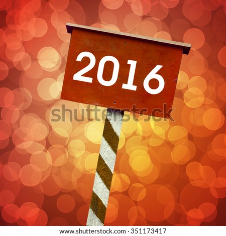 2016 board with red background with defocused lights bokeh