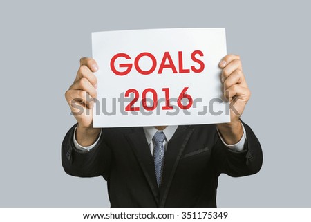 Goals 2016 placard. Man holding a paper with text