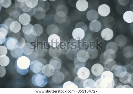 Picture of light blurred background with white bokeh lights on it. Festive holiday theme with copyspace
