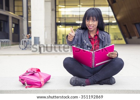 African Young girl studying with book

