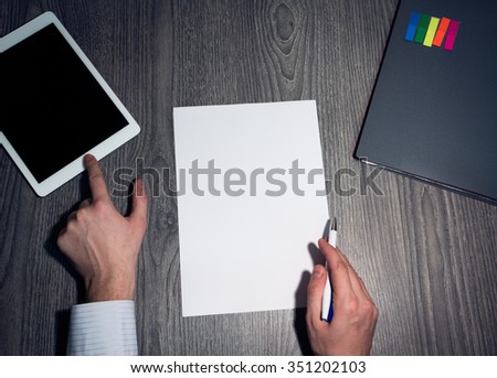Office man looking for information online. Hands writing on a paper. Business man signing a contract 