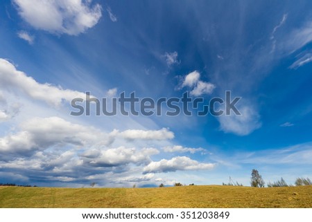 Green landscape blue cloudy sky